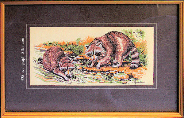 J & J Cash woven picture of two Raccoons