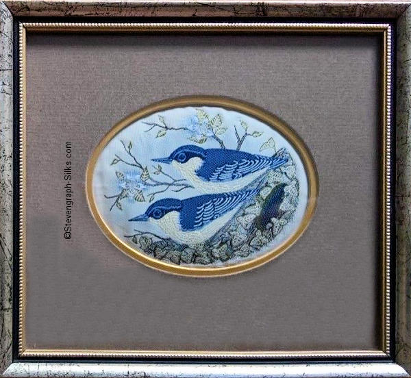 Framed woven picture of a pair of nuthatch birds, perched on a branch