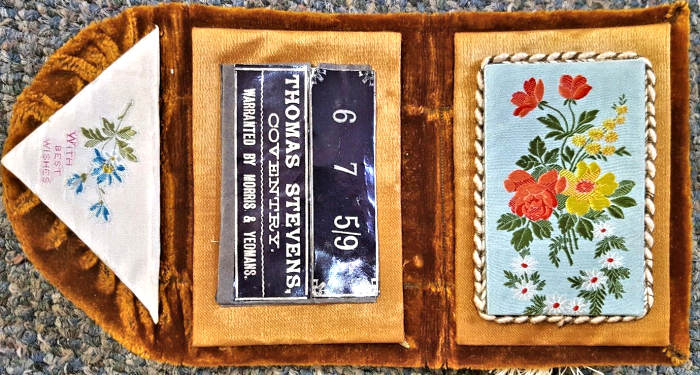 needle case with woven silk on the fold over flap, with words "With Best Wishes", and woven image of flowers