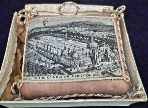 pin cushion with words " Woven In The Edinburgh Exhibition 1886 "