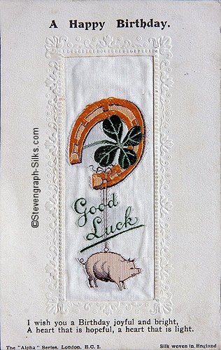 Alpha series postcard with woven GOOD LUCK words, image of four-leaf clover and a pig, with printed title