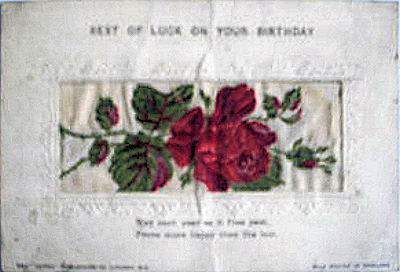 Alpha series postcard with no woven words, just image of a single rose and rose bud, with printed title and words below silk