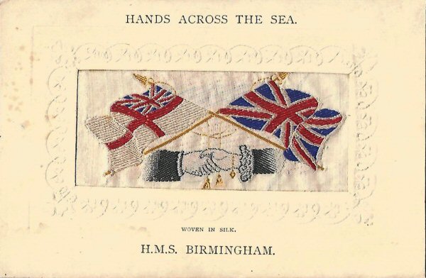 woven image of White Ensign & British flags, with Hands Across the Sea printed above silk, and ships name printed below silk