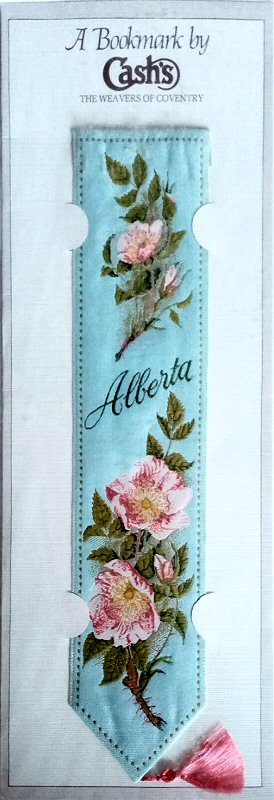 J & J Cash woven bookmark, with title word and images of wild roses