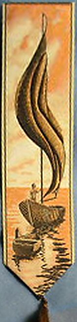 J & J Cash woven bookmark, with no words, but images of a sailing ship with a sunset behind