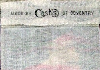 J & J Cash woven name on the reverse top turnover of this bookmark