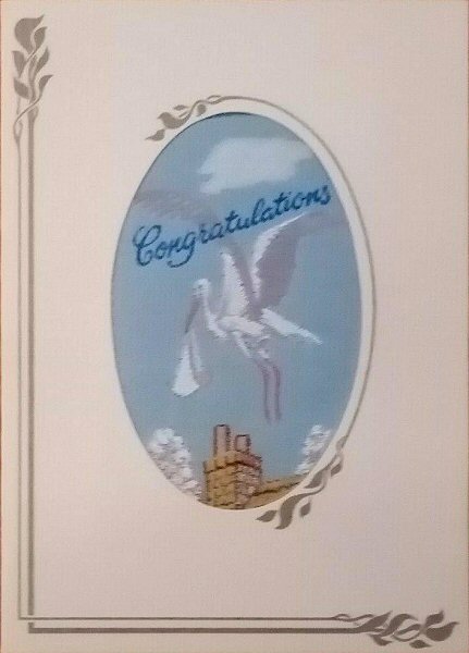 J & J Cash's greetings card with words woven on tapestry, Congratulations, and image of a stork with a baby
