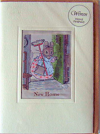 J & J Cash's greetings card with words woven on tapestry, NEW HOME, and image of a mouse holding a brush