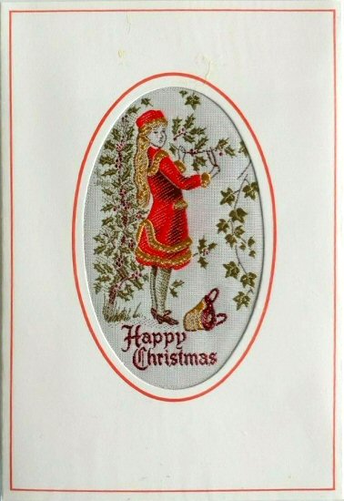 J & J Cash woven Christmas card, with HAPPY CHRISTMAS words, and image of woman collecting holly & ivy