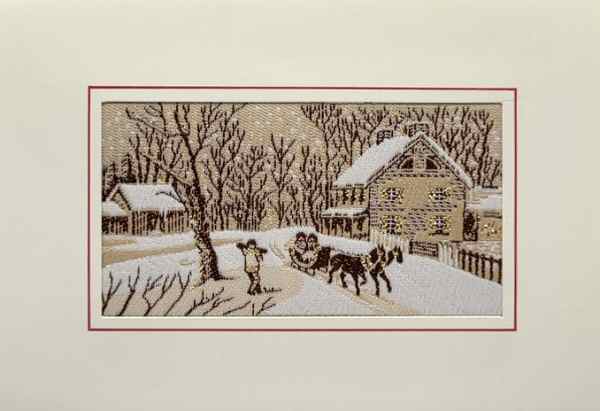 J & J Cash woven Christmas card, with no words, just image of snow scene with horse and sleigh, a man carrying of log of wood and buildings