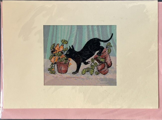 J & J Cash woven card, with no words, but picture of a black cat upsetting plant pots