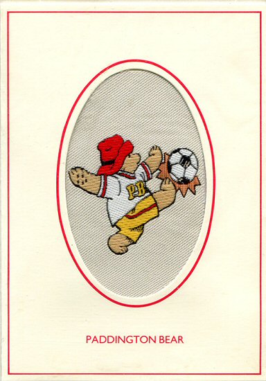 J & J Cash woven card, with title words only: Paddington Bear, but woven image of Paddington kicking a football