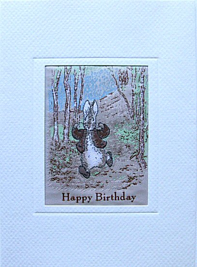 J & J Cash woven card, with " Happy Birthday " words, and image of Peter Rabbit in a wood