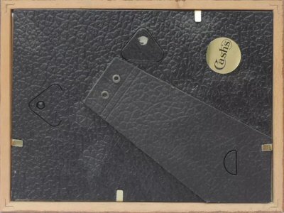 view of back of this framed card, showing the CASH's label