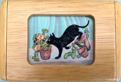J & J Cash wooden box with inlayed lid, with picture of a black cat among flowers and flower pats
