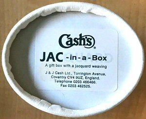 underside view of oval JAC-in-a-Box with J & J Cash printed label