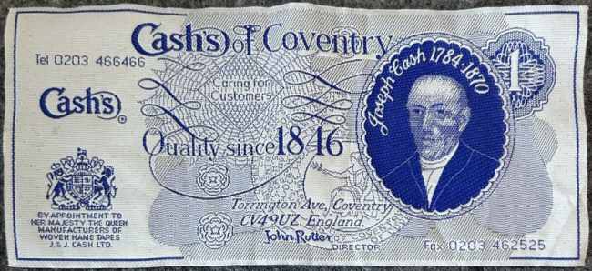 J & J Cash woven picture of an old British One Pound blue note