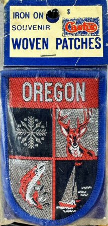 J & J Cash woven saw-on label with words: Oregon