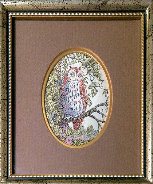 Framed woven picture of a sleepy owl