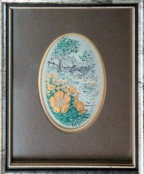 Framed woven picture of a Marigold flower