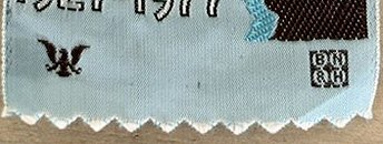 view of front bottom edge of this bookmark showing woven weavers initials