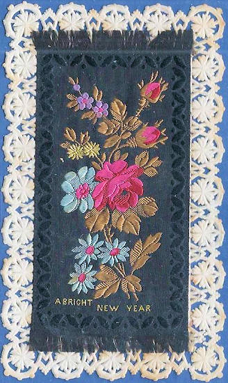 black rectangular silk mounted on card with ornate die-cut lace border - " A Bright New Year "