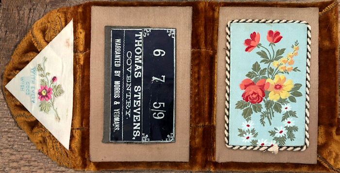 needle case with woven silk on the fold over flap, with words "With every good wish", and woven image of flowers